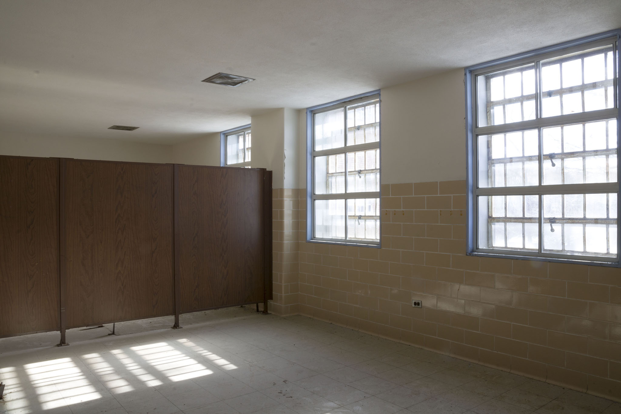 A dormitory for patients with wooden dividers.